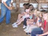 troop members planting bean seeds to take home